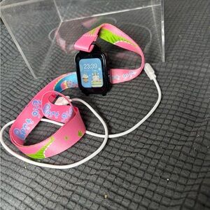 Vibrant Pink Kids XGO2 Smartwatch with Playful Strap and Charging Cord